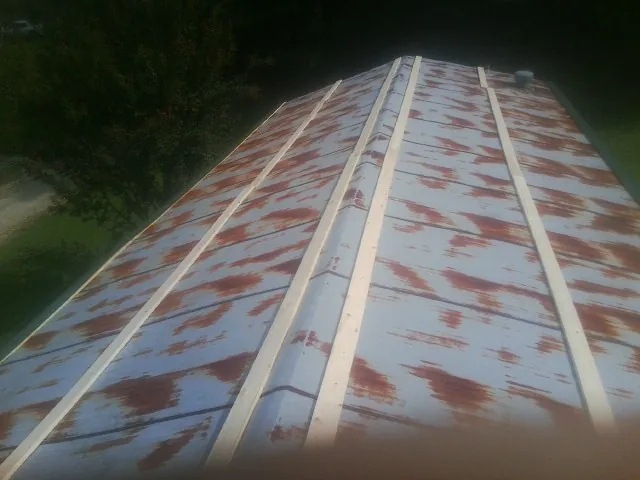 Rusted metal roof panels with new wood purlins before replacement — Storm Damage Roof Repair in Monteagle by Roofing Brothers