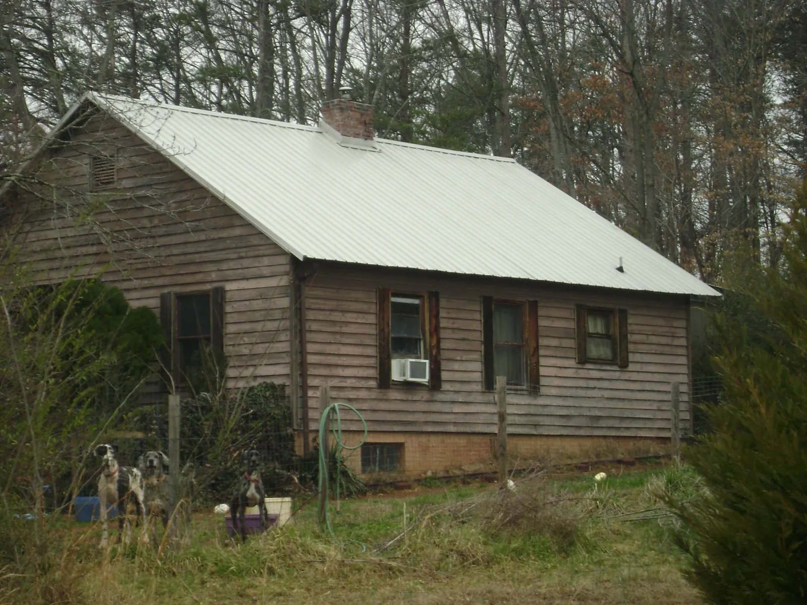 White metal roof on an old wood sided farmhouse, from a Metal Roof Installation job in Monteagle